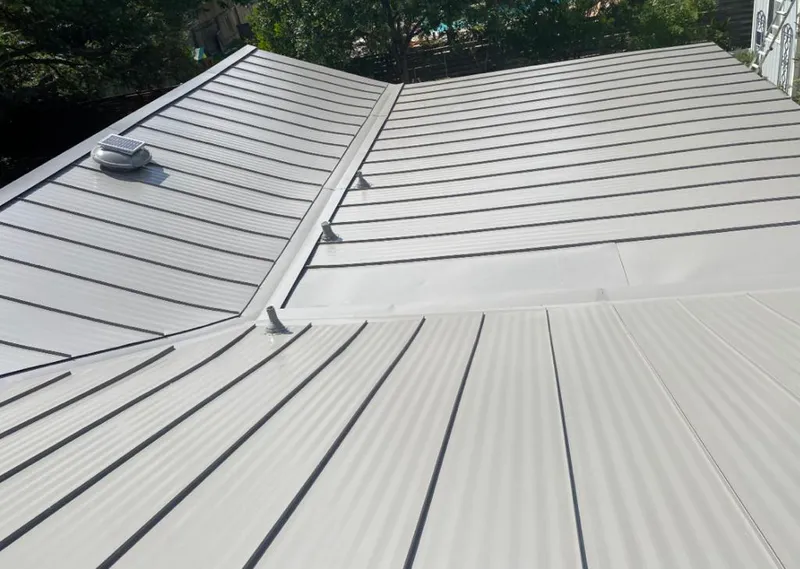 Solar attic fan installed on a metal roof for Roof Ventilation in Muscatine